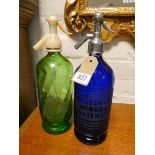 Two coloured glass soda siphons 12 1/4" high Blue one has one small chip to base,
