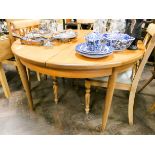 A 1970's GPlan circular teak extending dining table with fold away centre leaf 4' diameter