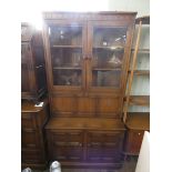 Ercol Golden Dawn, glazed two door bookcase with drinks compartment and cupboards under,