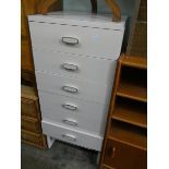 A pale pink painted Gplan tall boy chest of six drawers,