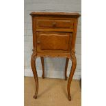 A French walnut bedside cabinet standing on cabriole legs with rouge patterned marble top