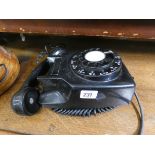 A black Bakelite wall fixing telephone