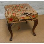 A Victorian walnut cabriole legged stool with upholstered seat