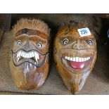 A pair of carved coconut masks