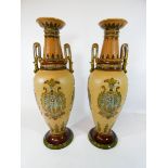 A pair of Mettlach twin handled vases decorated in shades of blue and beige in a Neo classical