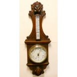 An Edwardian banjo style barometer in decorative carved oak case by John Harrop Ltd