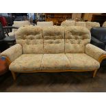 A GPlan style three seater settee in cream and floral covering