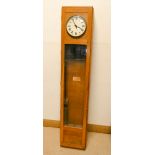 A Magneta electric slave clock in light oak and glazed case with enamel dial,