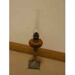 A late Victorian oil lamp with amber glass bowl on an onyx and metal base