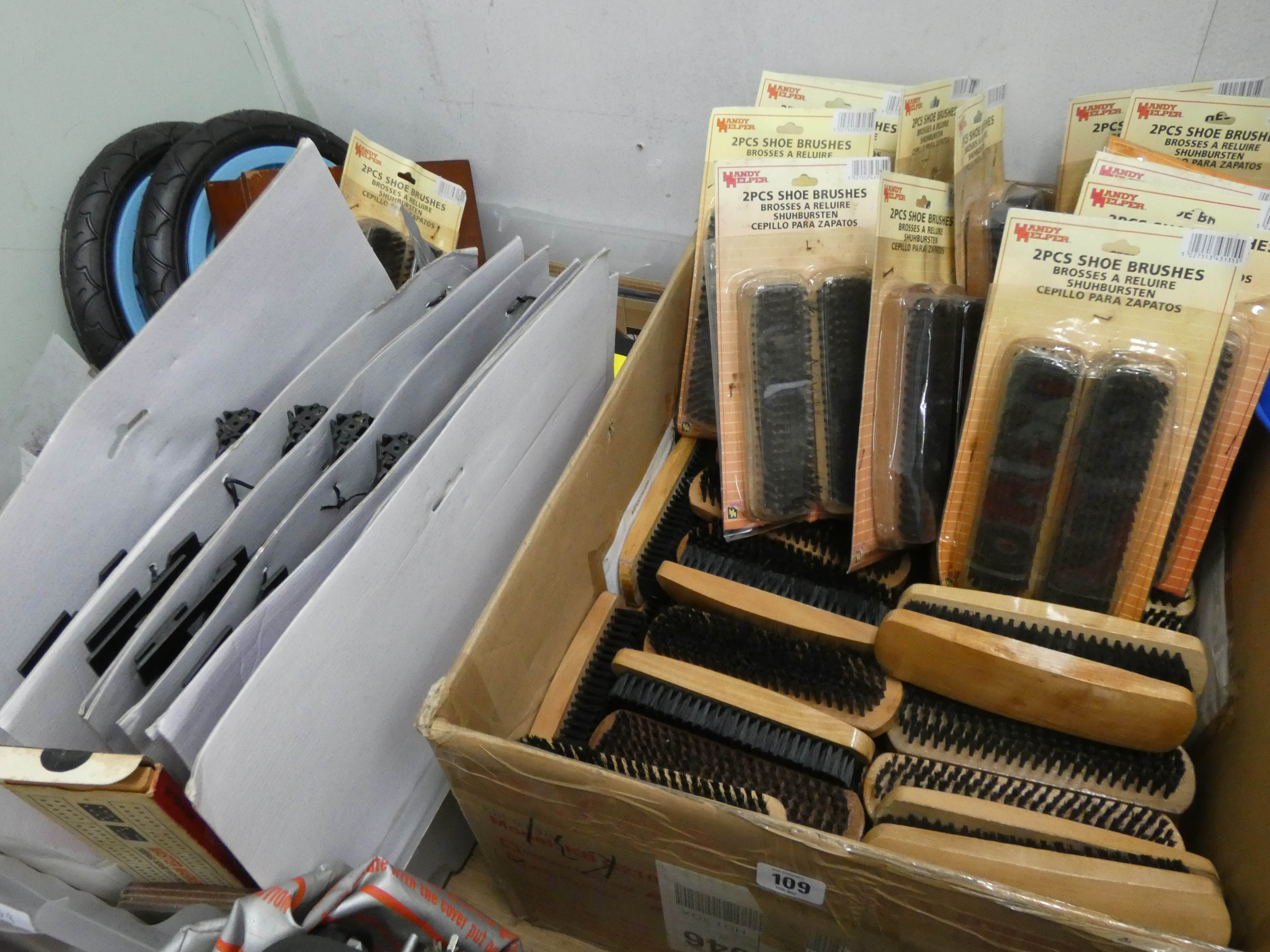 Two large boxes of shoe brushes,