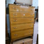 A pale mahogany chest of five long drawers with brass handles,
