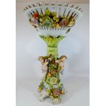 Dresden floral encrusted table centre piece with cherub band figural decoration to the column,