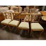 A set of four light beech dining chairs with green upholstered seats