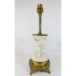 A Victorian parian lamp base on a gilt metal base modelled as cherubs wrestling,