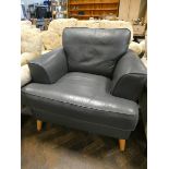 A modern easy chair in dark blue leather