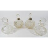 A pair of cut glass and silver mounted scent bottles and a pair of cut glass scent bottles