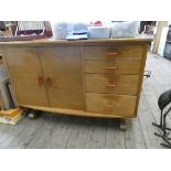 A chunky light oak dining suite comprising a drop leaf oval table,