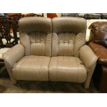 A two seater modern reclining settee in beige leather