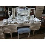 A GPlan limed oak finished knee hole dressing table with triple mirrors and matching stool,