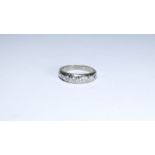 A diamond half hoop ring, unmarked white metal,