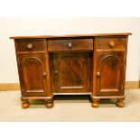 A Victorian mahogany kneehole desk or dressing table fitted three drawers and cupboards,