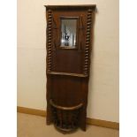 An oak hall stand with barley twist columns and oval umbrella stand,