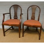 A set of eight Georgian style hooped back mahogany dining room chairs with serpentine seat fronts