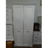 A modern white two door wardrobe,