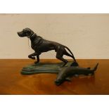 A bronze figure of a pointer dog and a bronze salmon