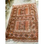 A large red and patterned Bokhara rug,