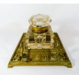 A Victorian brass desk stand with faceted glass inkwell,