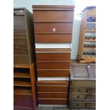 Three white and teak finished chest of drawers,
