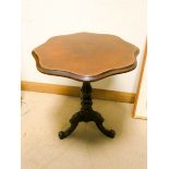 A Victorian shaped top walnut snap top occasional table on pillar on tripod base