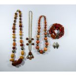 A large faux amber necklace and other bead necklaces