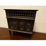 A miniature carved oak Breton style wardrobe with sliding doors 14" wide,