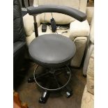 A vintage dentists or hairdressers adjustable chair