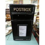 A black reproduction cast iron post box