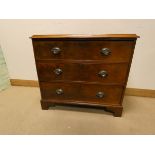 An early Victorian mahogany chest of three long drawers with oval brass handles standing on bracket