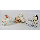 A group of three Royal Crown Derby rabbit shaped paperweights, Meadow Rabbit,
