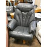 A modern revolving Stressless style easy chair in dark blue leather