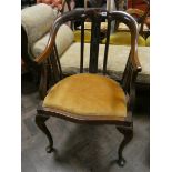 Edwardian mahogany tub shaped elbow chair with gold upholstered seat standing on cabriole style