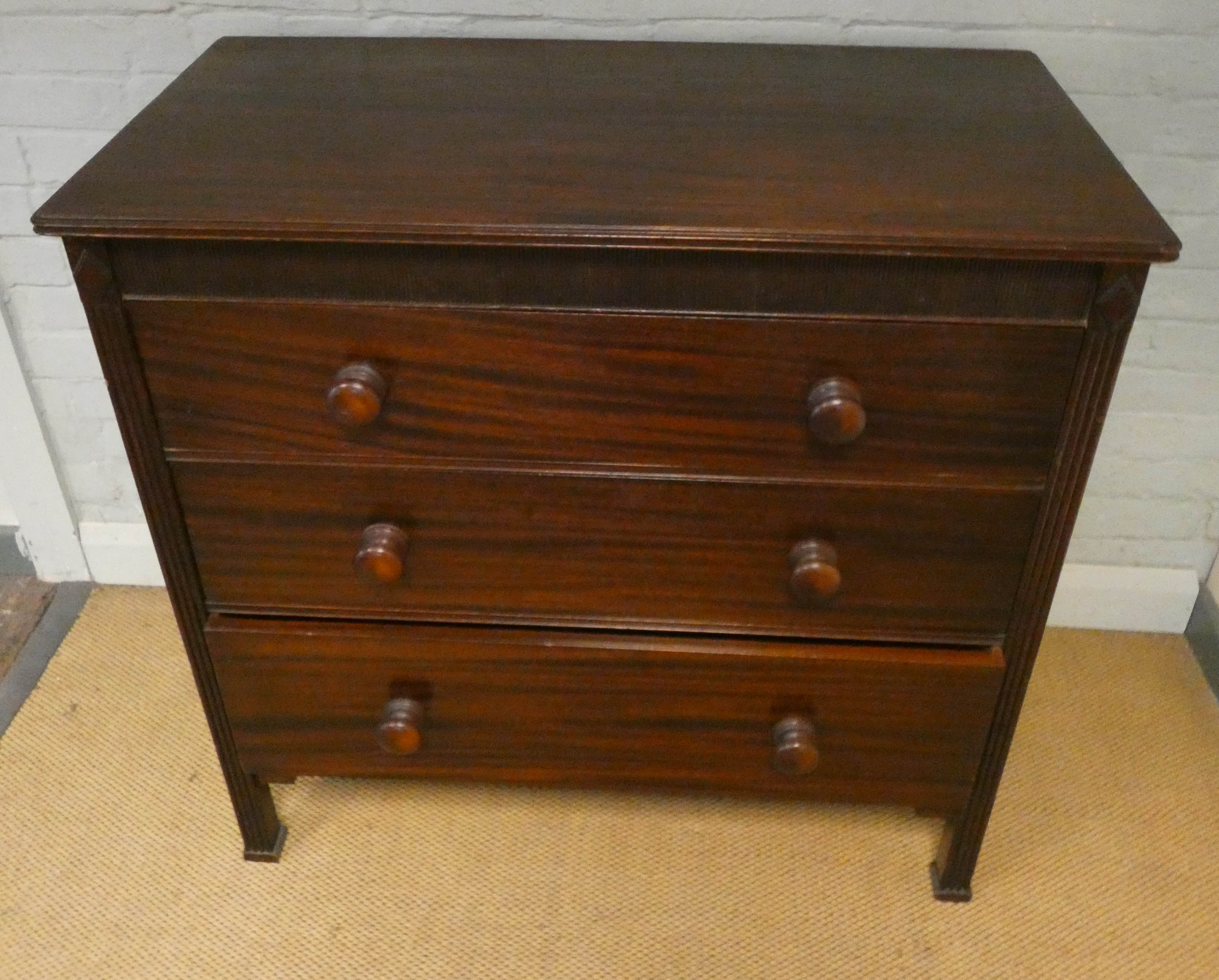 Victorian mahogany chest of three long drawers with bun handles standing on reeded style legs - Image 2 of 2