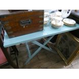 A square blue painted wooden garden table