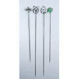 A collection of four Arts & Crafts silver hat pins by Charles Horner to include green stone set