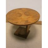 An Art Deco style circular figured walnut coffee table on shaped base