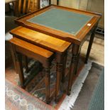 A nest of three square mahogany line inlaid coffee tables with green leather tops