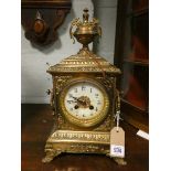 A French striking mantel clock by Japy Freres in decorative brass case with urn shaped finial