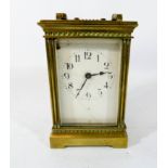 A gilt brass carriage clock with key 16cms with handle up Enamel cracked