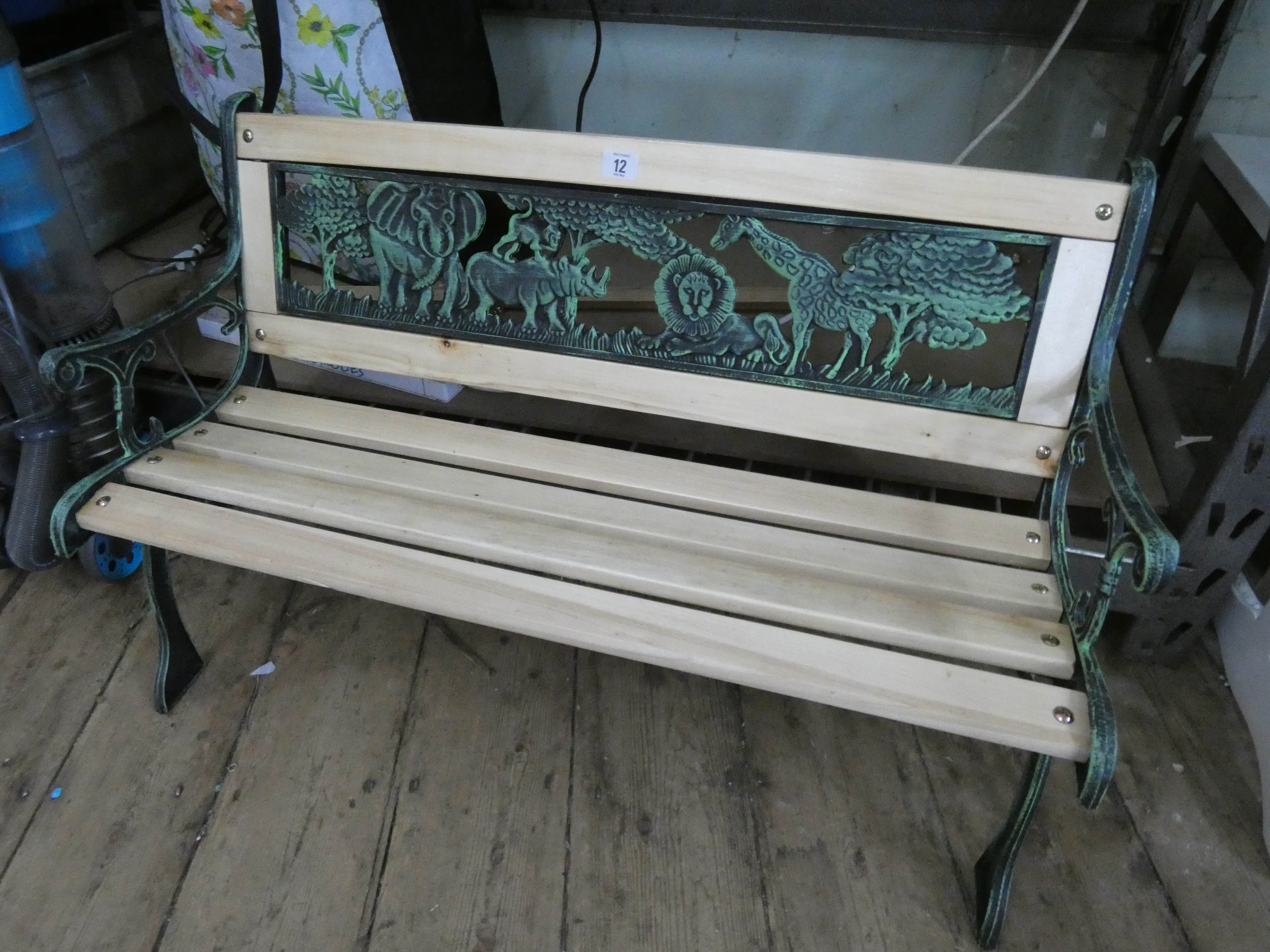 A small child's Victorian style metal ended garden bench with cast iron animal back