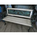 A small child's Victorian style metal ended garden bench with cast iron animal back
